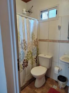 a bathroom with a toilet and a shower curtain at Mariposa 88 in Puerto Rico +30 photos