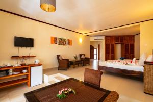 a hotel room with a bed and a living room at Sun Properties and Resort Hotel in Beau Vallon