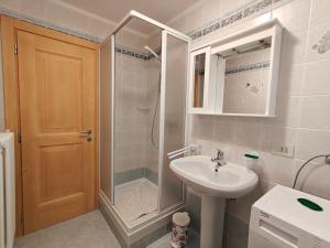 a bathroom with a shower and a sink and a shower at Appartamento panoramico 1 in Dosoledo