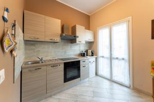 a kitchen with a sink and a stove at tra il borgo e il mare in Cervo +36 photos