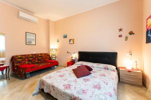 a bedroom with a bed and a couch at tra il borgo e il mare in Cervo