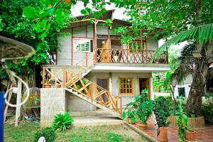 a house with a staircase in front of it at El Ranchito de Turbo in Turbo