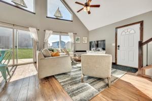 a living room with a ceiling fan and windows at Bridges Bay Vacation Cabin 126 in Arnolds Park