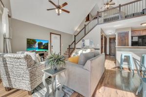 a living room with a couch and a table at Bridges Bay Vacation Cabin 126 in Arnolds Park +32 photos