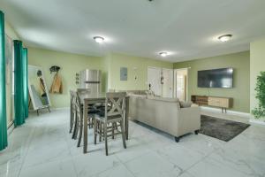 a kitchen and living room with a table and a couch at Explore NYC, Parks & Beaches! Top-Floor Apt in Mount Vernon