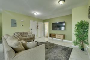 a living room with a couch and a table at Explore NYC, Parks & Beaches! Top-Floor Apt in Mount Vernon