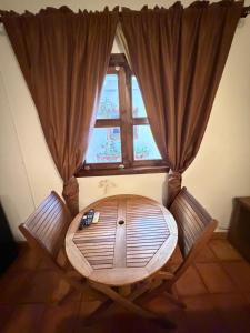 a room with a round table in front of a window at The Cabo Cush Hotel in Cabo San Lucas