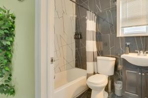 a bathroom with a toilet and a tub and a sink at Explore NYC, Parks & Beaches! Top-Floor Apt in Mount Vernon +16 photos