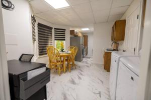 a small kitchen with a table and chairs in it at Studio•Basement• Back Entry Basement•1BRD•Ste B in Lawrenceville