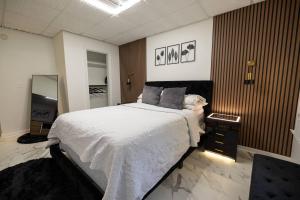a bedroom with a large bed and a television at Studio•Basement• Back Entry Basement•1BRD•Ste B in Lawrenceville