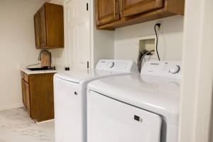 a laundry room with a white washer and dryer at Studio•Basement• Back Entry Basement•1BRD•Ste B in Lawrenceville +9 photos