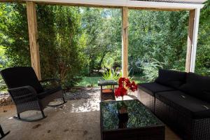 a screened in porch with a couch and a chair at Studio•Basement• Back Entry Basement•1BRD•Ste B in Lawrenceville