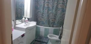 a bathroom with a sink and a toilet and a mirror at Apartment Mitrou in Loutra Oraias Elenis +34 photos