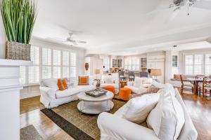 a living room with white furniture and a table at Beach cottage with private pool & spa, ocean views, & shared pool access in Saint Simons Island