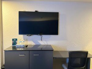 a flat screen tv hanging on a wall at Hotel Corona Plaza in Rosarito