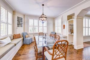 a living room with a table and chairs and a couch at Beach cottage with private pool & spa, ocean views, & shared pool access in Saint Simons Island