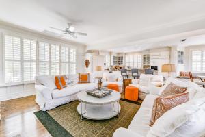 a living room with white furniture and windows at Beach cottage with private pool & spa, ocean views, & shared pool access in Saint Simons Island