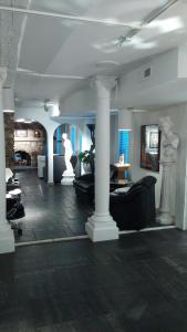 a living room with couches and columns in a building at Mario's International Spa, Hotel & Restaurant in Aurora