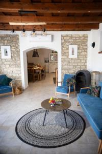 a living room with a table and a blue couch at Pirk Vendégház Vászoly in Vászoly