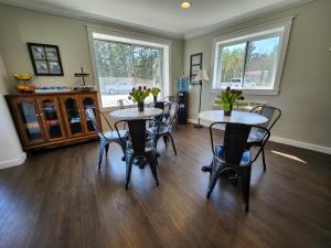a dining room with two tables and chairs at Brio Beach Inn in Traverse City