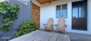 two chairs sitting on the porch of a house at Lar da Rita - One bedroom apartment in Água Retorta +4 photos