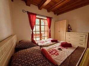 a bedroom with two beds and a window at Apartmán Jezerné in Velké Karlovice