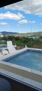 a swimming pool on the roof of a building at Anima Lodge in Villa Carlos Paz