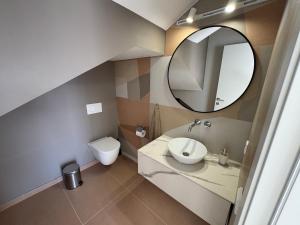 a bathroom with a sink and a mirror at Sea view villa San Agustin vista Claveles in San Agustin +20 photos
