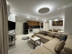 a living room with a couch and a table at Vila Marjana in Sarandë