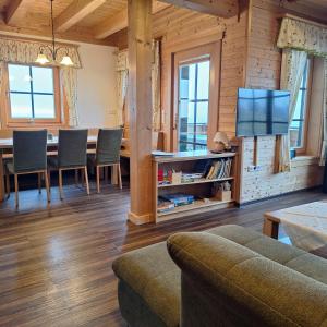 a living room with a couch and a table with a television at Ferienhaus Hochfelner in Sankt Marein bei Knittelfeld