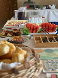 a table with a bunch of food on it at Hotel Carvalho in Bragança Paulista