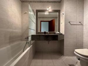 a bathroom with a sink and a mirror at Forum Madeira dla par in Funchal +29 photos