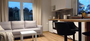 a living room with a couch and a kitchen at Domek w okolicy Karpacza in Marczyce +20 photos