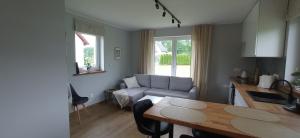 a living room with a table and a couch at Domek w okolicy Karpacza in Marczyce