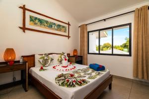 a bedroom with a bed with a cake on it at Sun Properties and Resort Hotel in Beau Vallon +26 photos