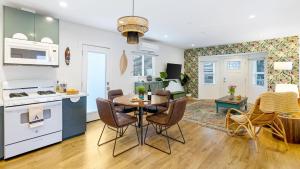 a kitchen and living room with a table and chairs at Urban Jungle by AvantStay in Los Angeles