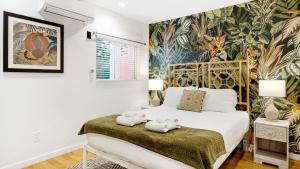 a bedroom with a bed with teddy bears on a bench at Urban Jungle by AvantStay in Los Angeles
