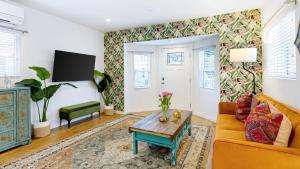 a living room with a couch and a table at Urban Jungle by AvantStay in Los Angeles