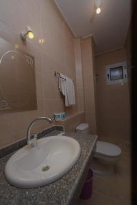 a bathroom with a sink and a toilet at sunrise house in Luxor +17 photos