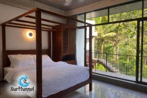 a bedroom with a bed and a balcony at Surftunnel Beach Resort in Weligama