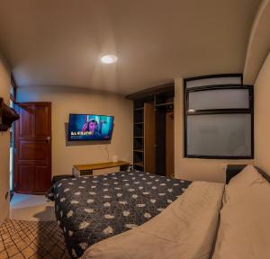 a bedroom with a bed and a flat screen tv at Apartment E18 UPAO 2nd Floor in Trujillo