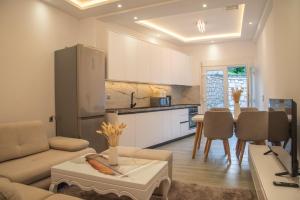 a living room with a couch and a kitchen at Villa Voka in Acharavi