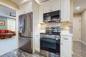a kitchen with a stove and a refrigerator at Work, Play & Stay! Apt Near Holyoke Medical Center in Holyoke