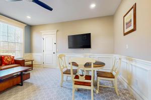 a living room with a table and chairs and a tv at Work, Play & Stay! Apt Near Holyoke Medical Center in Holyoke