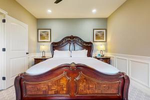 a bedroom with a large wooden bed with white sheets at Work, Play & Stay! Apt Near Holyoke Medical Center in Holyoke