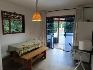 a living room with a table and a refrigerator at Rancho Primavera in Santana do Riacho