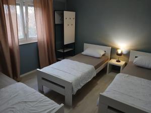 a small room with two beds and a mirror at Landhaus Olive in Čitluk +35 photos