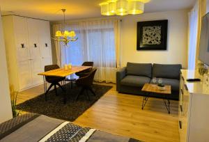 a living room with a table and a couch at Ferienwohnung Waldrose am Titisee in Titisee