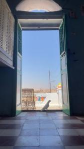 an open door to a room with a chair outside at Safeya Kato in Jazīrat ‘Awwāḑ