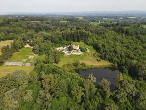 an aerial view of a house on an island in the forest at les bois de saint auvent in La Geneytouse